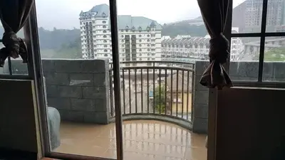 a view of a balcony from an open window at Crown Imperial Court - Arsad Homestay Brinchang in Brinchang