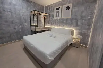 a bedroom with a large white bed in it at The Cozy Hotel in Sungai Petani