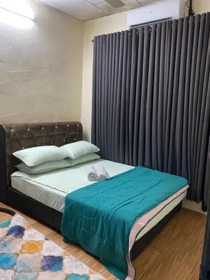 a bedroom with a bed with a large window at laman terrace stays in Sungai Petani