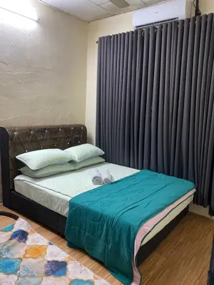 a bedroom with a bed with a large window at laman terrace stays in Sungai Petani