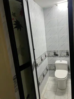 a bathroom with a toilet and a glass door at laman terrace stays in Sungai Petani