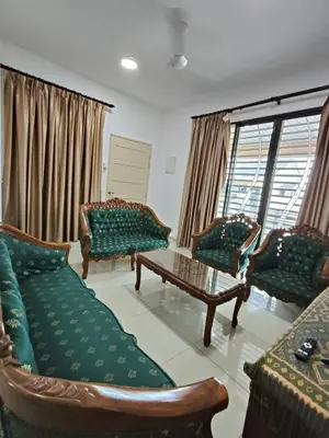 a living room with couches and a coffee table at Bertam Wawasan Homestay in Kepala Batas