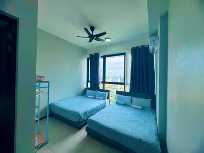 a bedroom with two beds and a ceiling fan at urban suites 3BR 10pax b30 infinity pool in Jelutong