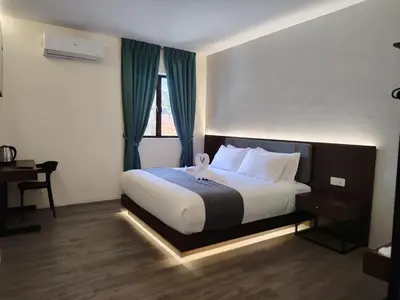 a bedroom with a large bed with a window at The Great Hotel Sri Iskandar in Seri Iskandar