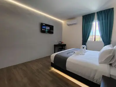 a hotel room with a bed and a television at The Great Hotel Sri Iskandar in Seri Iskandar