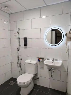 a bathroom with a toilet and a sink at The Great Hotel Sri Iskandar in Seri Iskandar