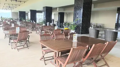 a dining room with wooden tables and chairs at ICC Suites Ipoh City Center, New & cozy, 6 Pax in Ipoh