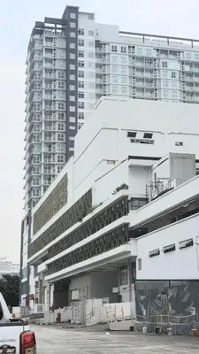 a large white building in front of a tall building at ICC Suites Ipoh City Center, New & cozy, 6 Pax in Ipoh