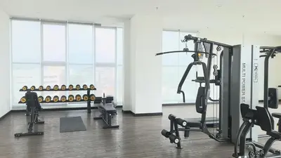 a gym with several treadmills and machines in a room at ICC Suites Ipoh City Center, New & cozy, 6 Pax in Ipoh