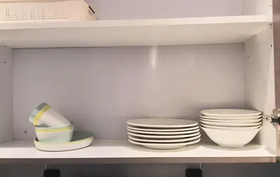 two stacks of plates and bowls on a shelf at ICC Suites Ipoh City Center, New & cozy, 6 Pax in Ipoh