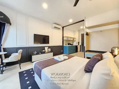 a bedroom with a large bed and a tv at 22 Macalisterz George Town by Wodages in George Town