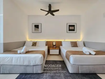 a bedroom with two beds and a ceiling fan at 22 Macalisterz George Town by Wodages in George Town