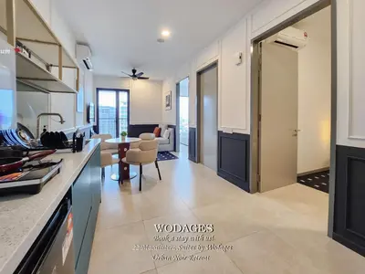a kitchen and living room with a table and a dining room at 22 Macalisterz George Town by Wodages in George Town