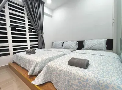 two beds sitting next to each other in a bedroom at H2H - Welcome Home - Majestic Ipoh - 5pax in Ipoh