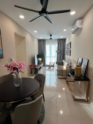 a living room with a table and a ceiling fan at Cozy Modern Condo with Pool & City Access in Bayan Lepas