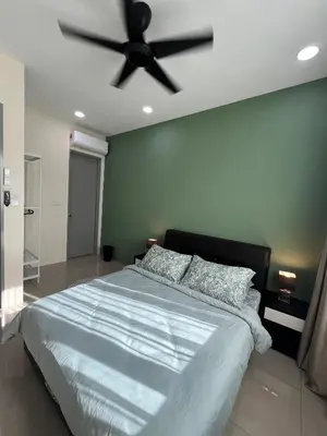 a bedroom with a large bed with a ceiling fan at Cozy Modern Condo with Pool & City Access in Bayan Lepas