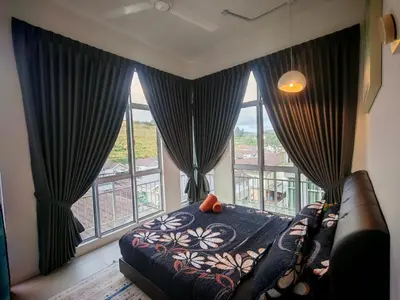 a bedroom with a bed and a large window at Studio BARRINGTON SQUARE II in Brinchang