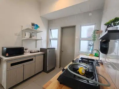 a kitchen with a stove and a sink in it at Studio BARRINGTON SQUARE II in Brinchang