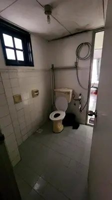 a bathroom with a toilet in a room with a window at Nina's Apt Parkview CH in Tanah Rata