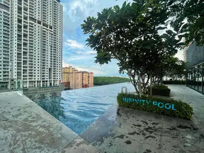 a infinity pool with a tree in the middle of a city at SeaView Premium Family Suite 3B2R in George Town