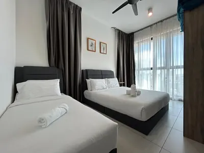a hotel room with two beds and a window at SeaView Premium Family Suite 3B2R in George Town
