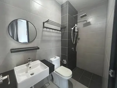 a bathroom with a sink and a toilet and a mirror at SeaView Premium Family Suite 3B2R in George Town