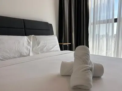 a pair of socks on a bed with a window at SeaView Premium Family Suite 3B2R in George Town