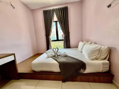 a bedroom with a large bed with a window at The Horizon Ipoh Skyline by Grab A Stay in Ipoh