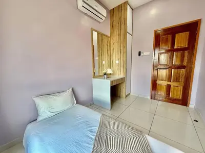 a bedroom with a bed and a sink and a mirror at The Horizon Ipoh Skyline by Grab A Stay in Ipoh