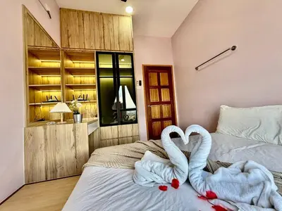 two swans making a heart on a bed in a bedroom at The Horizon Ipoh Skyline by Grab A Stay in Ipoh