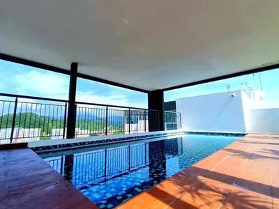 a swimming pool with a view of the ocean at The Horizon Ipoh Skyline by Grab A Stay in Ipoh