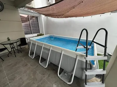 a hot tub in a patio with a table at Huwayna Private Pool Homestay M U S L I M sahaja in Kepala Batas