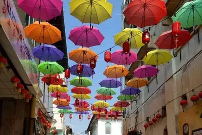 a bunch of colorful umbrellas hanging from a building at IPOH The Majestic Ipoh Town View Fully Air-Con Home in Ipoh