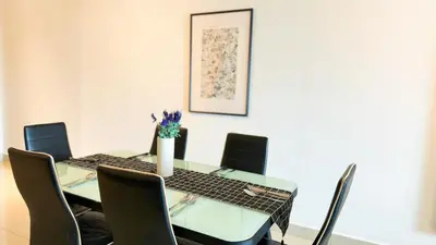 a dining room table with chairs and a vase on it at IPOH The Majestic Ipoh Town View Fully Air-Con Home in Ipoh