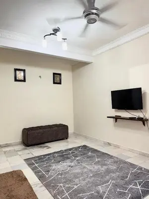 a living room with a couch and a flat screen tv at Ribat Homestay in Gerik