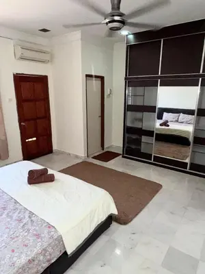 a bedroom with a bed and a large mirror at Ribat Homestay in Gerik