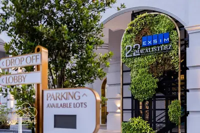 a building with two signs in front of a building at 22Macalisterz by MC Home in George Town