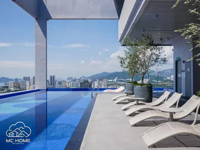 a swimming pool with lounge chairs on a building at 22Macalisterz by MC Home in George Town