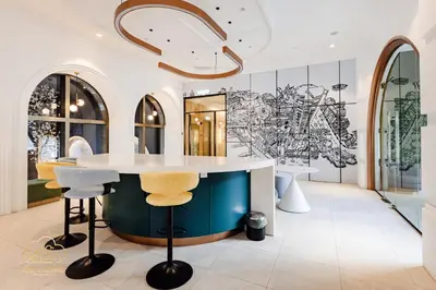 a kitchen with a table and stools at 22Macalisterz by MC Home in George Town