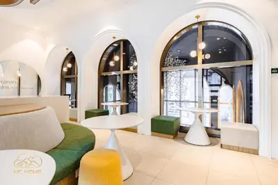 a store with arched windows and tables and chairs at 22Macalisterz by MC Home in George Town