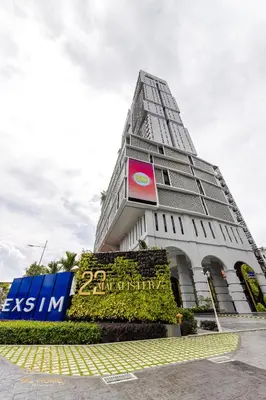 a building with a sign in front of it at 22Macalisterz by MC Home in George Town