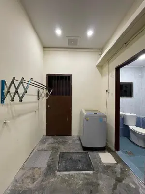 a room with a bathroom with a toilet and a door at GURNEY DRIVE Family-friendly Cozy Retreat 2-6 pax in George Town