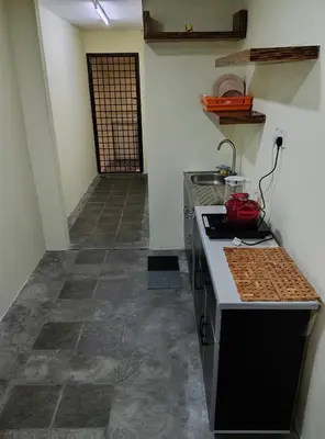 a kitchen with a stove and a counter top at GURNEY DRIVE Family-friendly Cozy Retreat 2-6 pax in George Town
