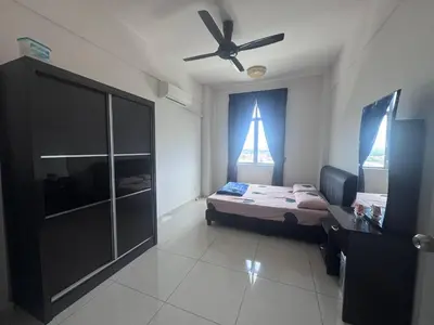 a bedroom with a bed and a ceiling fan at BG Roomstay in Ipoh