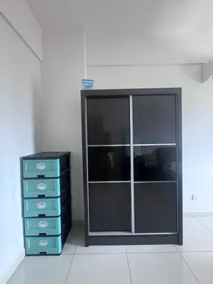 a room with a dresser and a glass cabinet at BG Roomstay in Ipoh