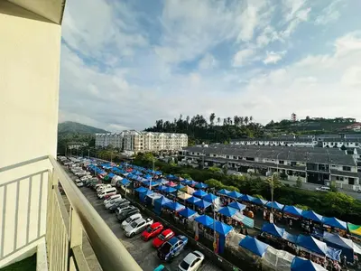 a parking lot filled with cars and blue umbrellas at Homestay Golden Hills in Brinchang