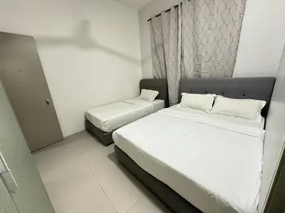 a small bedroom with two beds and a window at Homestay Golden Hills in Brinchang
