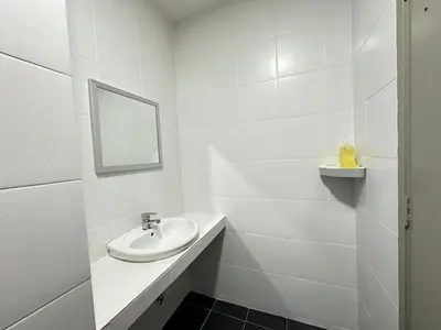 a white bathroom with a sink and a mirror at Homestay Golden Hills in Brinchang