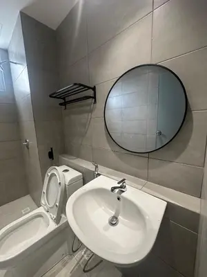 a bathroom with a sink and a mirror and a toilet at Metropol by BRB in Bukit Mertajam