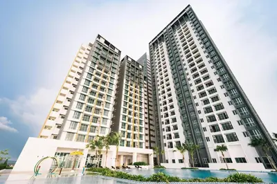 two tall buildings with palm trees in front of them at Metropol by BRB in Bukit Mertajam
